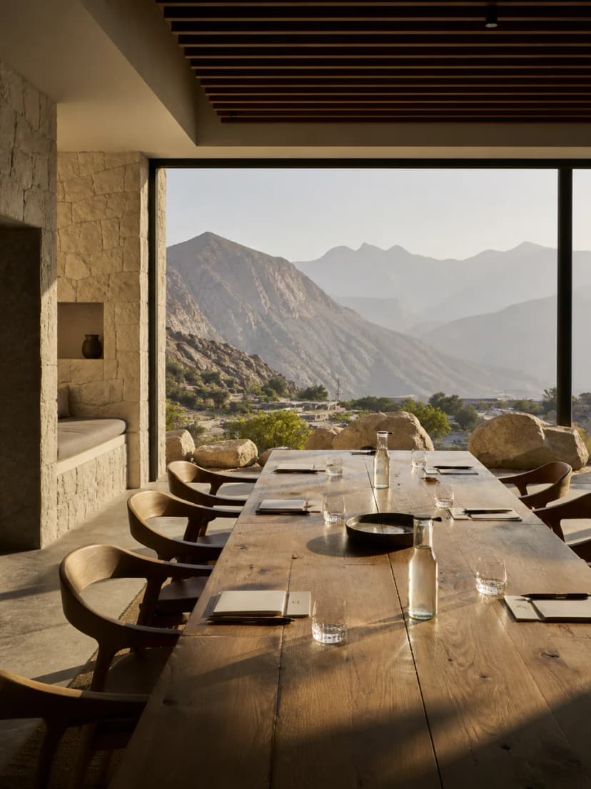 Stone meeting table overlooking the Hajar Mountains from a UAE retreat.