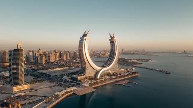Aerial view of Fairmont Doha in Katara Towers beside the Lusail waterfront.